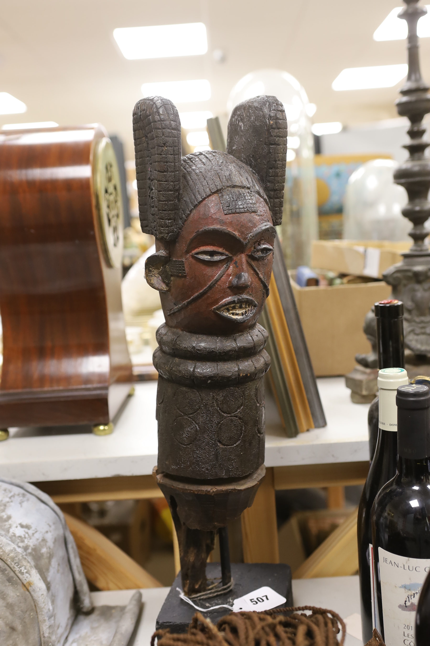 A Massai apron, dan mask and an African carving